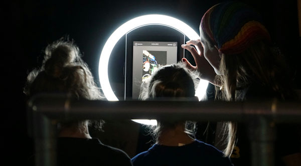 child with ring light in front of them